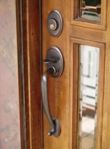 Close-up of front entry door handle on woodgrain door in Muncie.